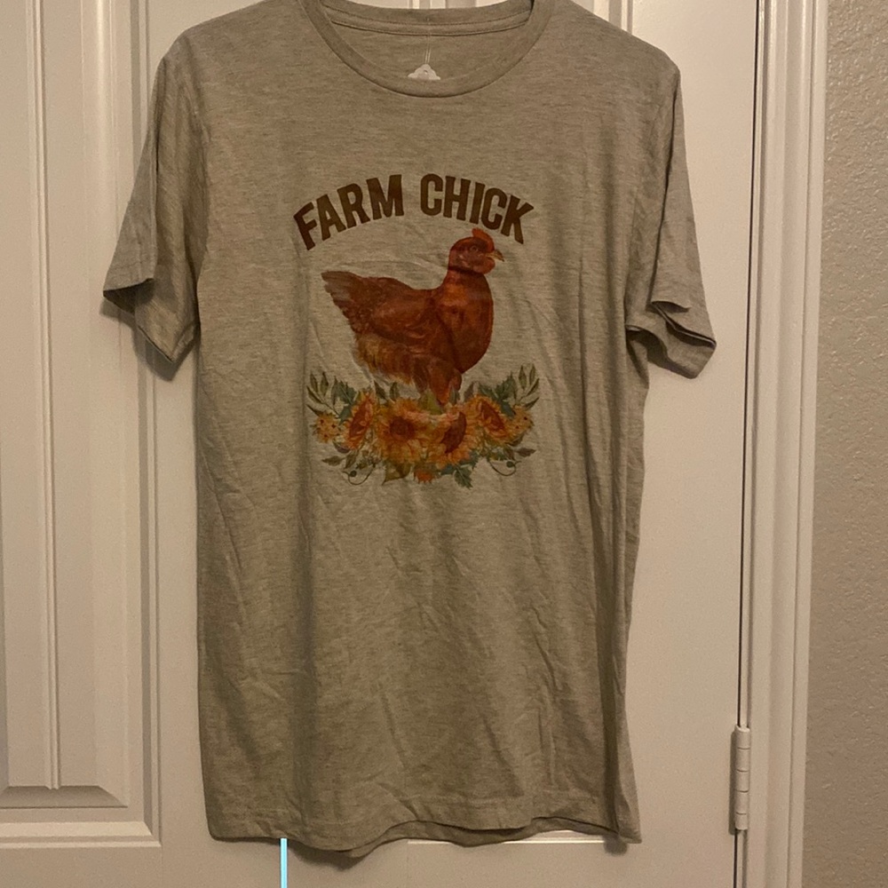 Small tan colored t-shirt with sunflower and chicken Farm Chick design